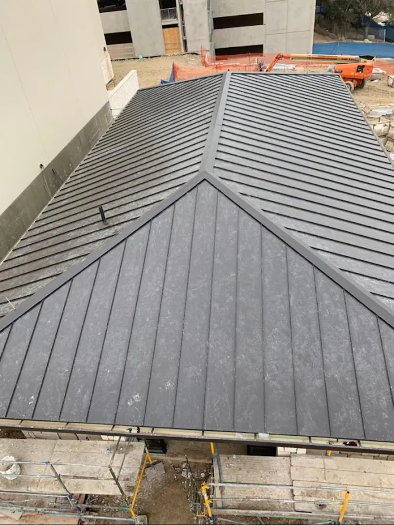Commercial metal roof construction with crane equipment in Madeira